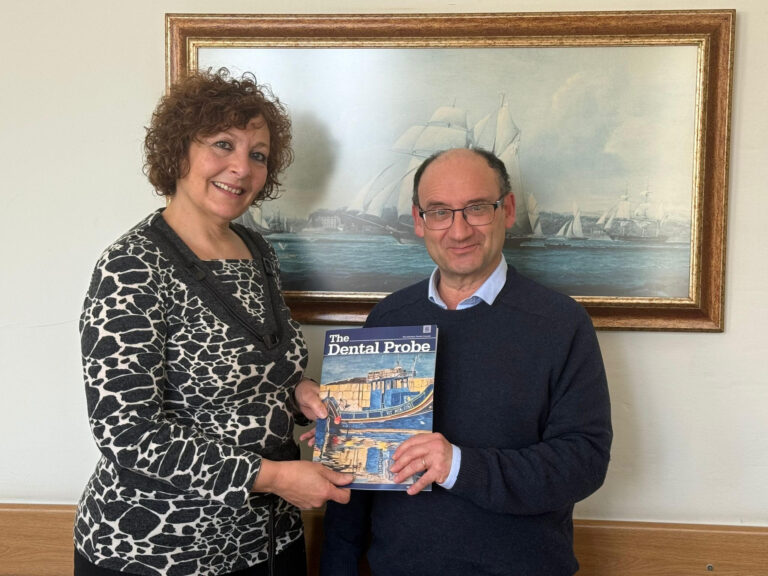 Dr Muscat presents a copy of The Probe to Professor Charmaine Gauci Superintendent of Public Health